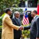 Ethiopian Prime Minister And Malaysian Leaders Shaking Hands Outdoors.