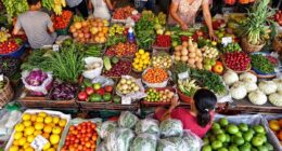 Colorful Malaysian Market With Fresh Produce And Shoppers.