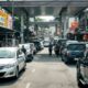 Malaysian Street With Fuel Stations And Cars Waiting.