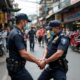 Police Arresting A Suspect In A Busy Street.