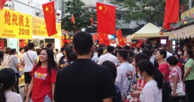 Crowd At Malaysian Cultural Event With China Flags.