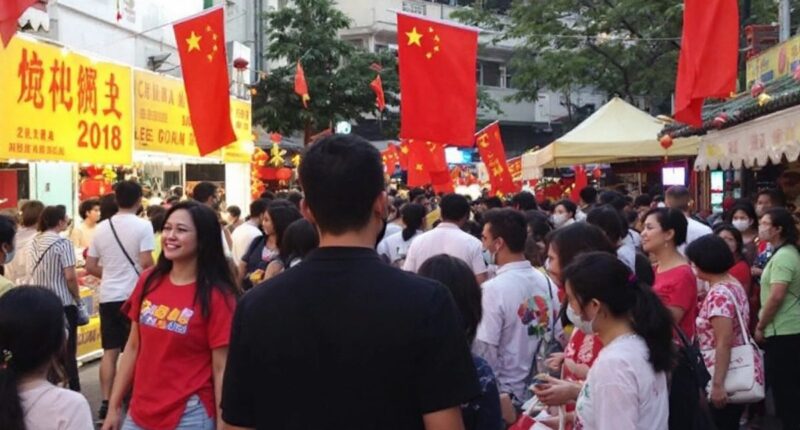 Crowd At Malaysian Cultural Event With China Flags.