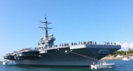 Uss Abraham Lincoln Docked In Malaysia With Naval Personnel.