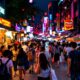 Nighttime Street Scene With Tourists Shopping In Malaysia.