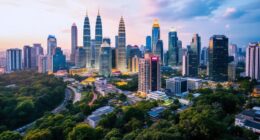 Kuala Lumpur Skyline With Greenery, Reflecting Malaysia'S Transformation.